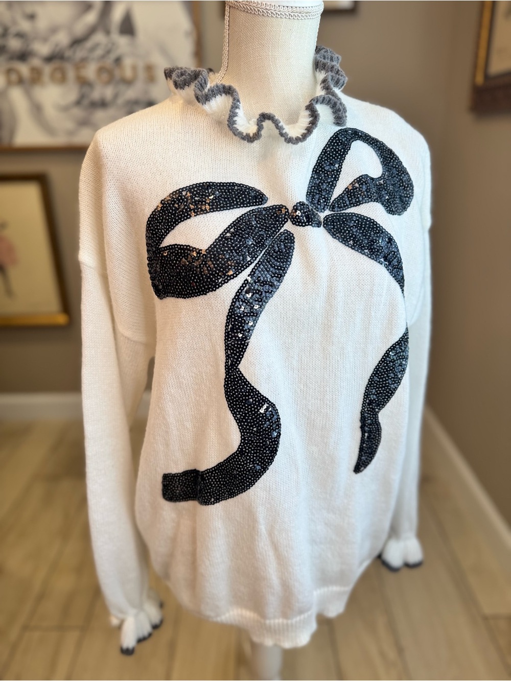 BiBi Off White Ruffle Trim Sweater with Black Sequin Bow